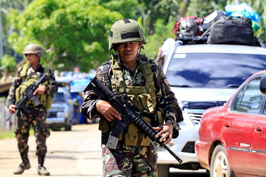 Gunmen take Catholic hostages; Philippines' Duterte imposes martial law