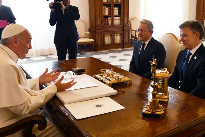 Pope meets with Colombia's president and opposition rival at odds on peace deal