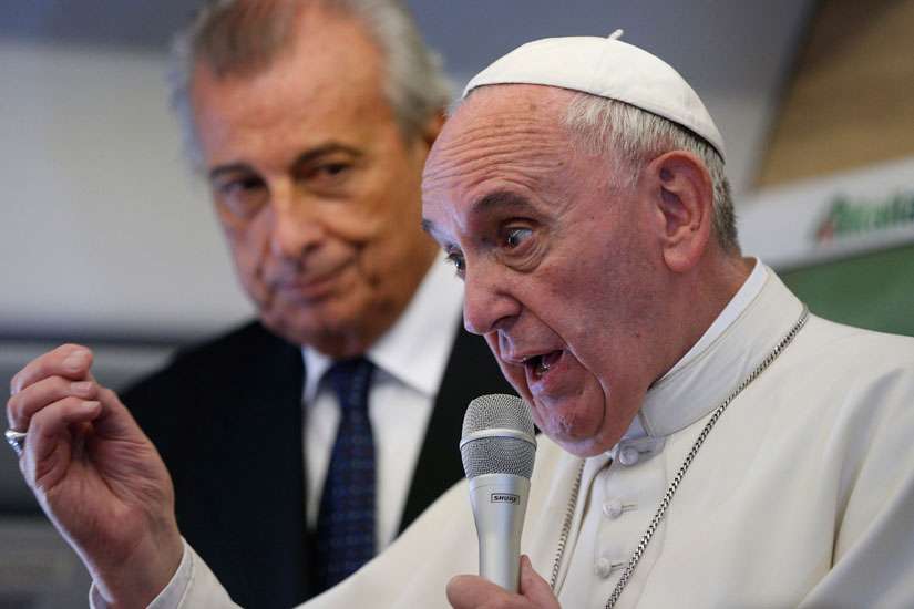 Meeting reporters on plane, Pope defends his teaching on social issues