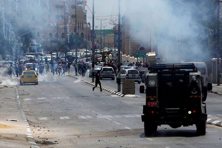 West Bank priests stress nonviolence as youths protest Israeli occupation