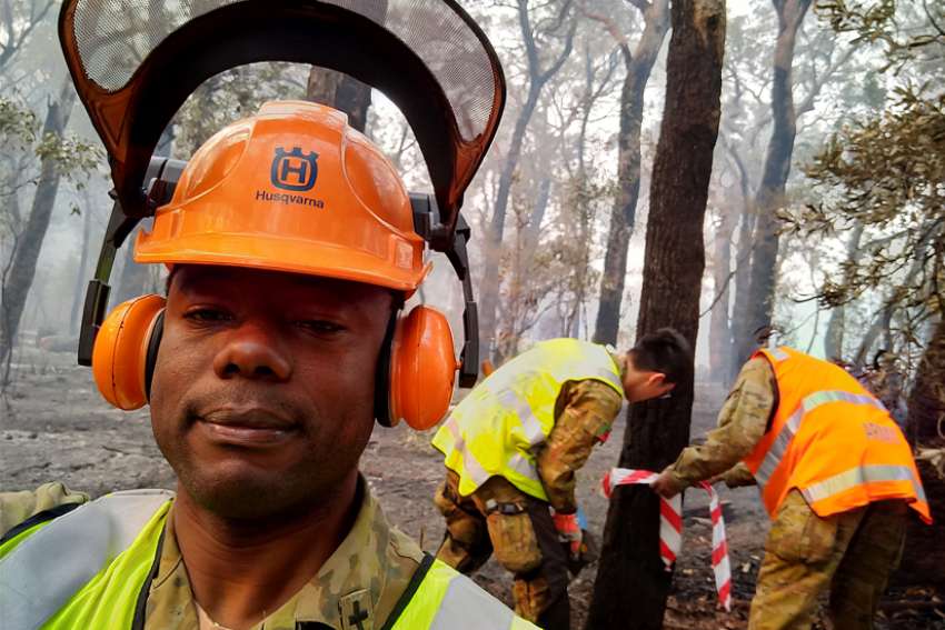 Swapping collars for camo: Priests help fight fires in Australia