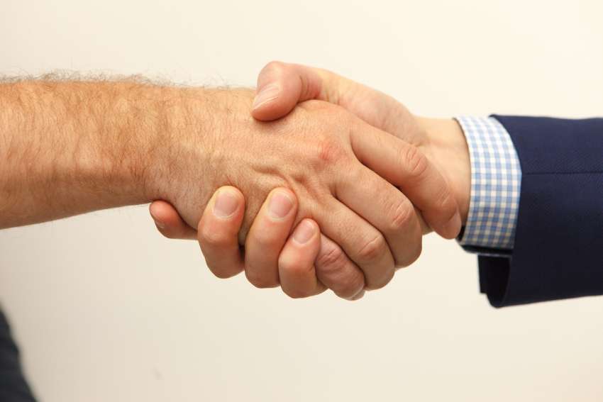 Charity demands shaking hands at Mass