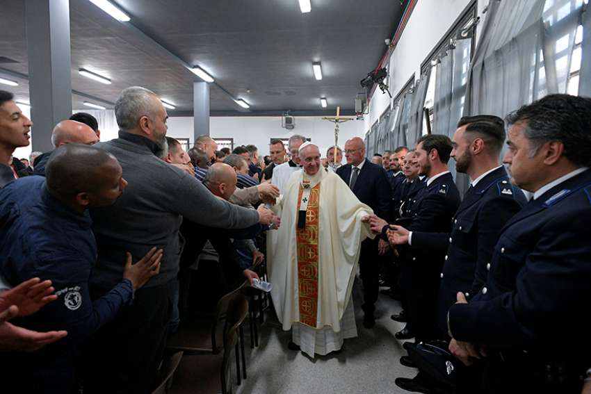 Be servants to one another, pope tells prisoners before washing feet