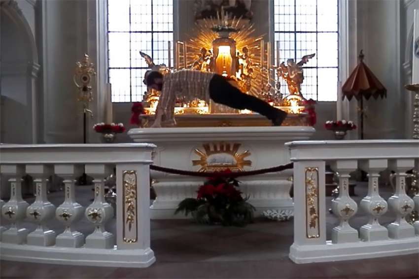 German artist performs pushups on altar, posts video, gets fined.