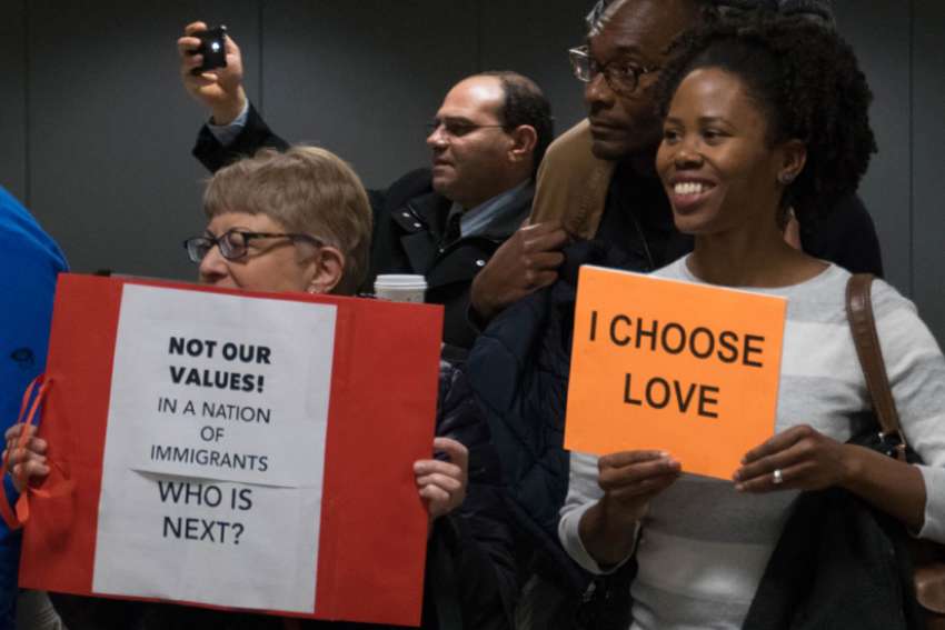Protesters gather at airport over refugee ban, greet arriving travellers