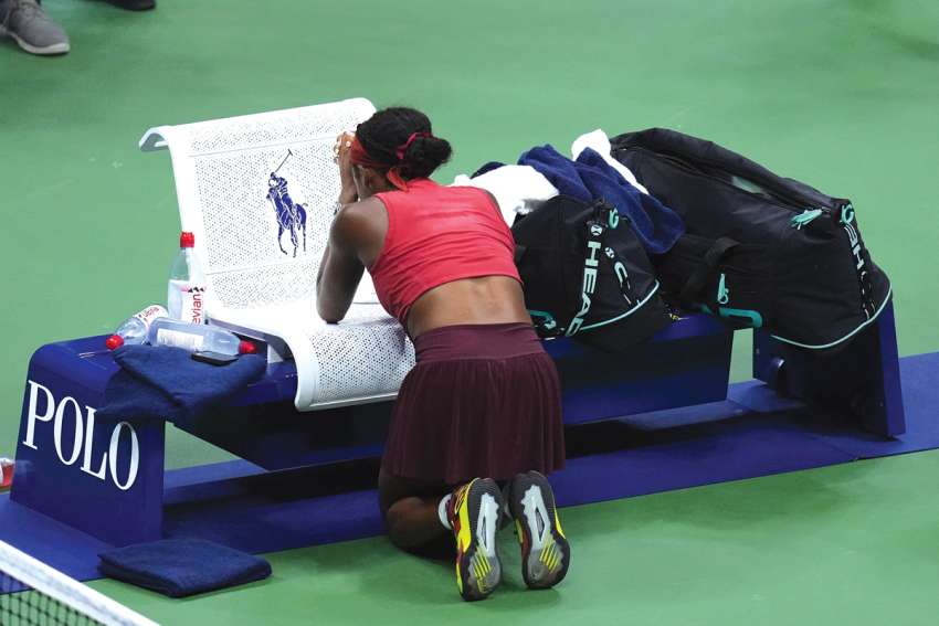 Tennis champ praying, not ‘taking it all in’