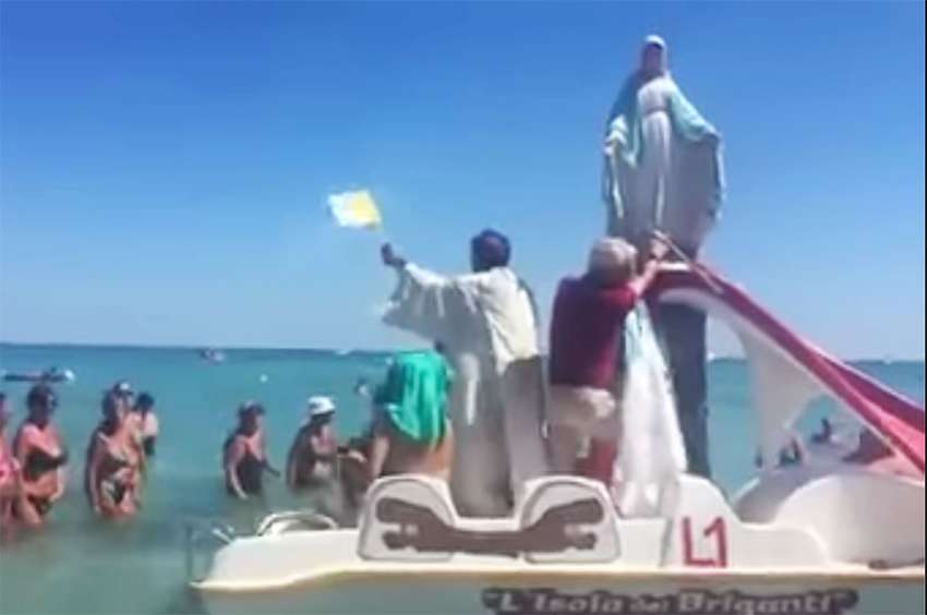 Italian priest takes Virgin Mary on a paddle boat to bless beachgoers