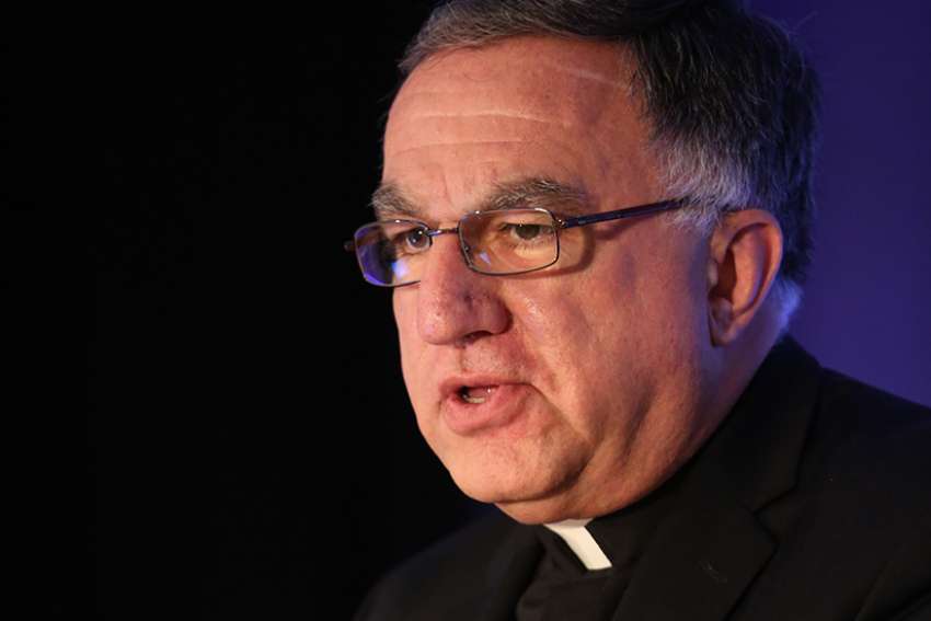Salt + Light board stands behind Fr. Rosica