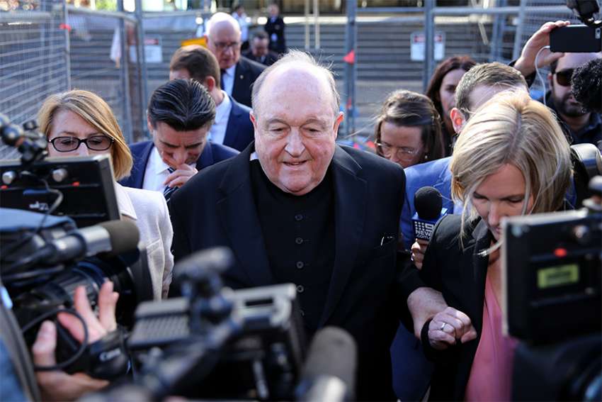 Australian archbishop, convicted of abuse cover-up, will stand aside for now