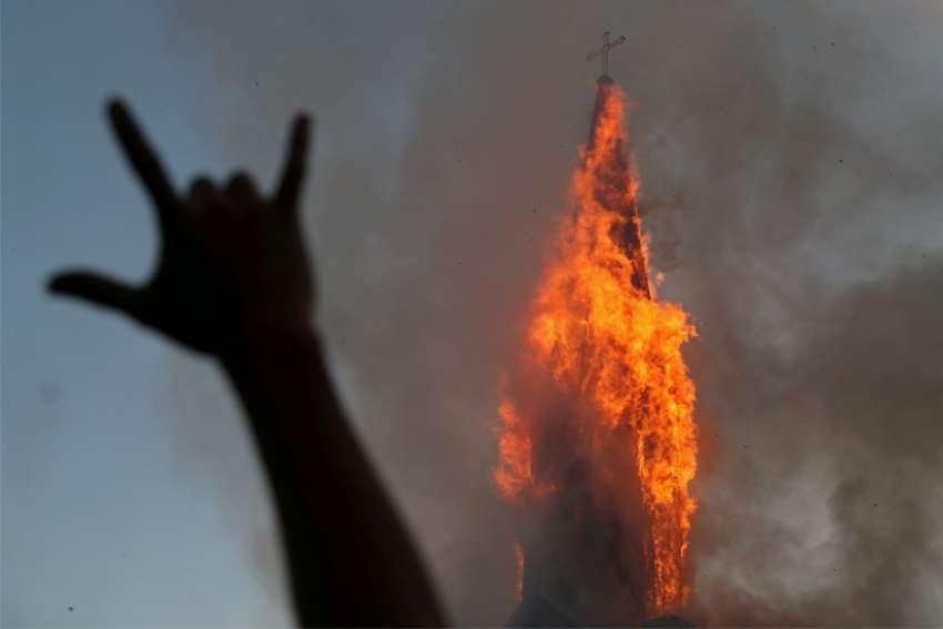 Demonstrators burn two churches in Chile on anniversary of protests