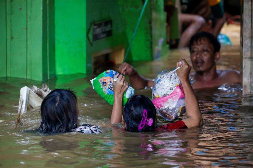 Church workers join aid distribution after Jakarta floods leave 60 dead