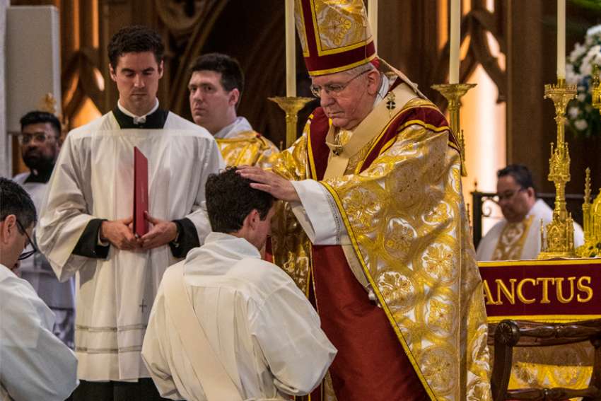 Cardinal Collins ordains four, calls them to conform to Christ