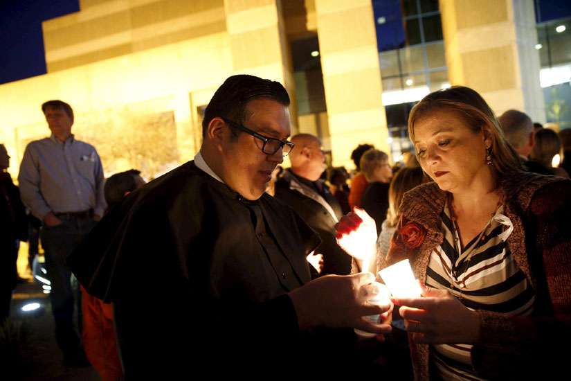 Attendees at vigil pray for shooting victims, for healing in community