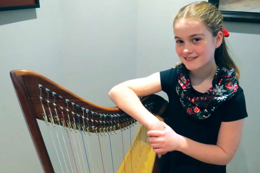Young harpist provides light in darkness