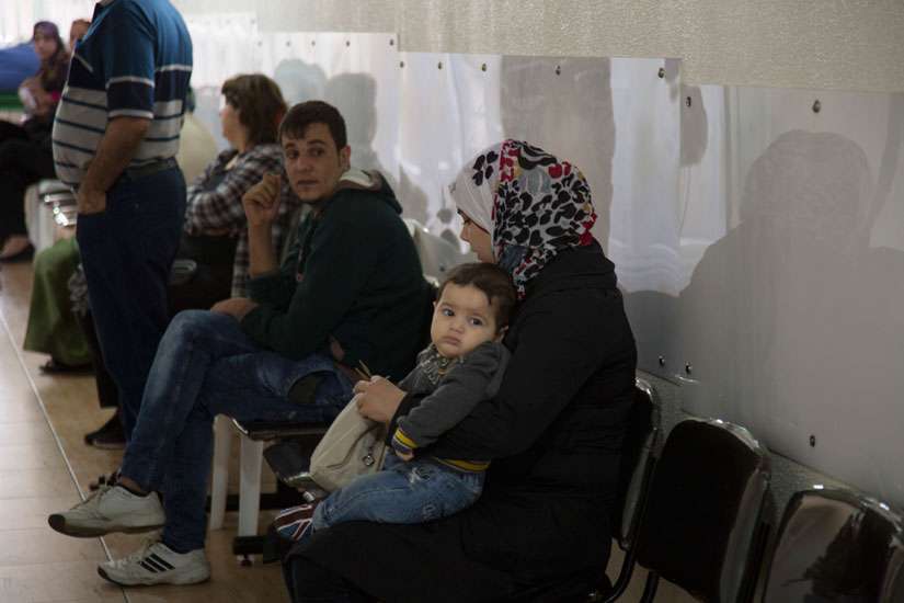 Refugees in Lebanon, facing new reality, get help at Catholic-run clinic